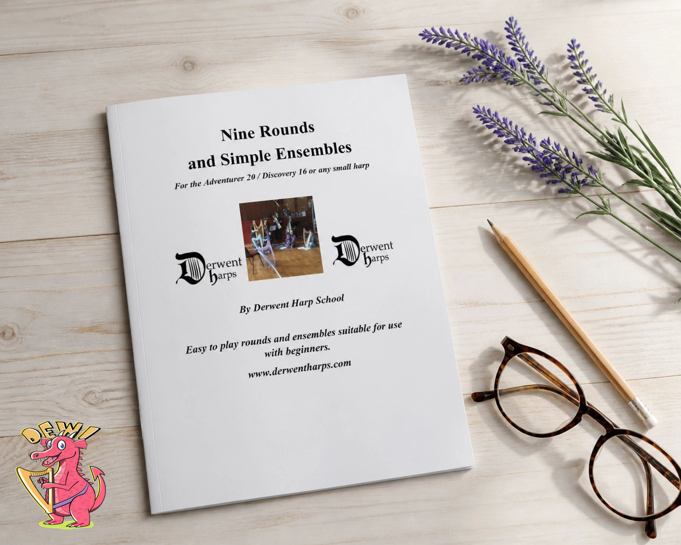 Sheet music for 'Nine Rounds and Simple Ensembles' by Derwent Harp School on a wooden surface with lavender and glasses.
