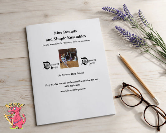 Sheet music for 'Nine Rounds and Simple Ensembles' by Derwent Harp School on a wooden surface with lavender and glasses.