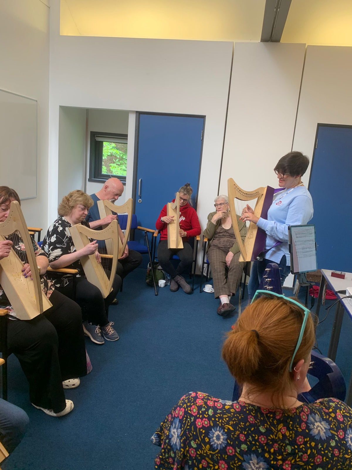 Beginner harp students learning to play Discovery 16 harps during a Discover The Harp workshop in Orkney.